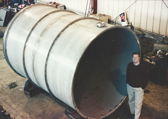 Patrick Smith, VP, inspecting large stainless steel waste water treatment tank prior to loading. Patrick Smith, VP, inspecting large stainless steel waste water treatment tank prior to loading.